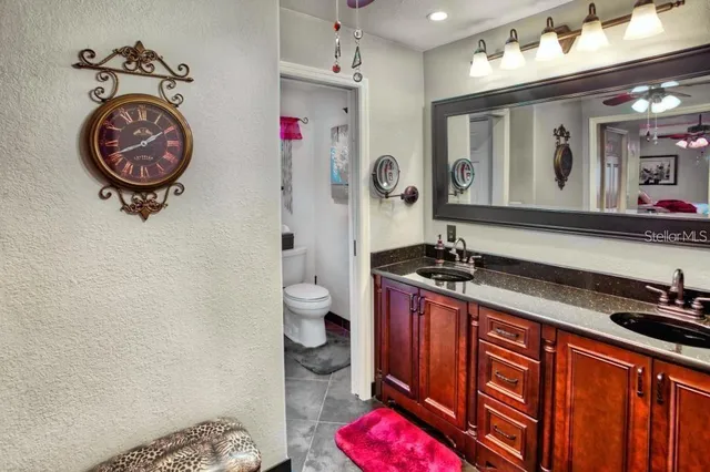 a bathroom with a sink a toilet and a mirror