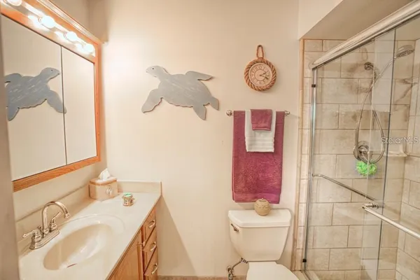 a bathroom with a sink mirror toilet and shower