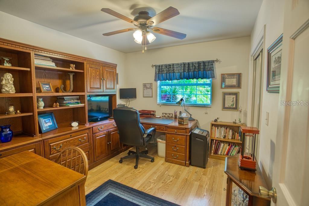 12802 North 53rd Street Temple Terrace, FL 33617 - Photo 19 of 38 a view of a workspace with furniture and a window