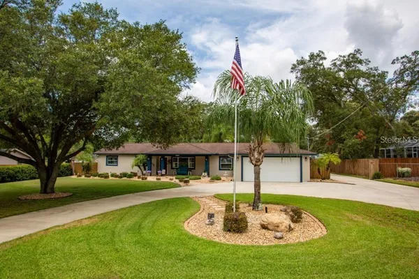 a swimming pool with outdoor seating and yard