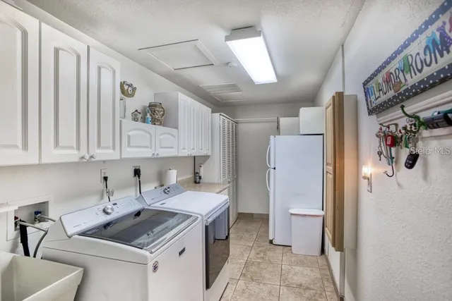 a kitchen with a sink stove and refrigerator