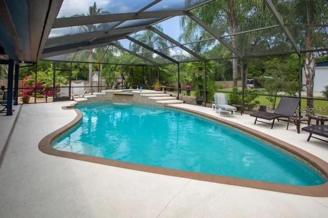 a view of a swimming pool with a patio