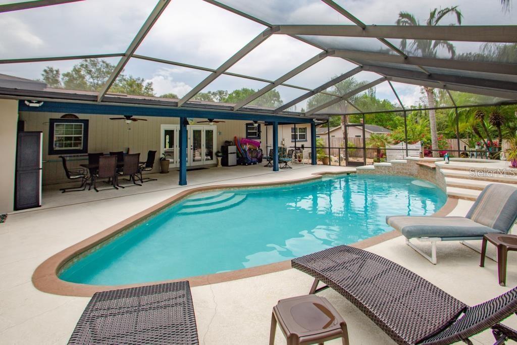 12802 North 53rd Street Temple Terrace, FL 33617 - Photo 23 of 38 a view of a patio with a table chairs and a table