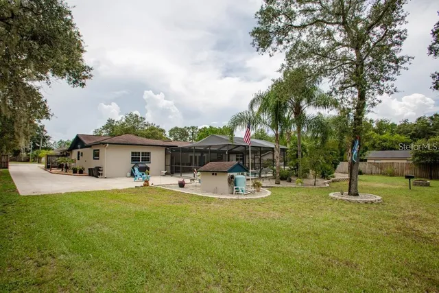 a view of a house with backyard porch and sitting area