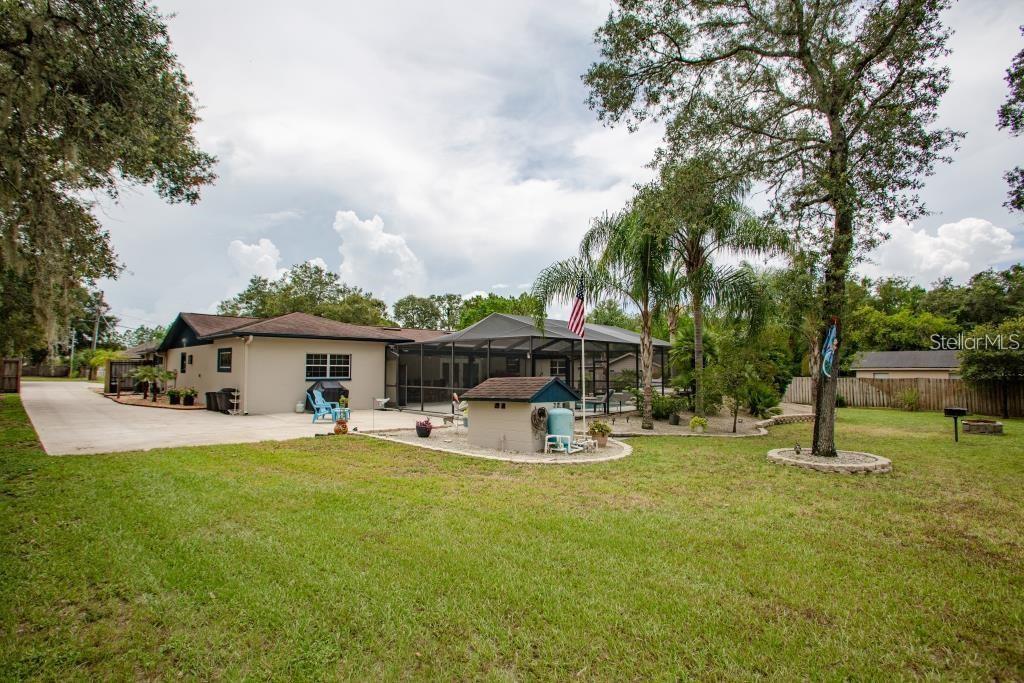 12802 North 53rd Street Temple Terrace, FL 33617 - Photo 26 of 38 a view of a house with backyard porch and sitting area