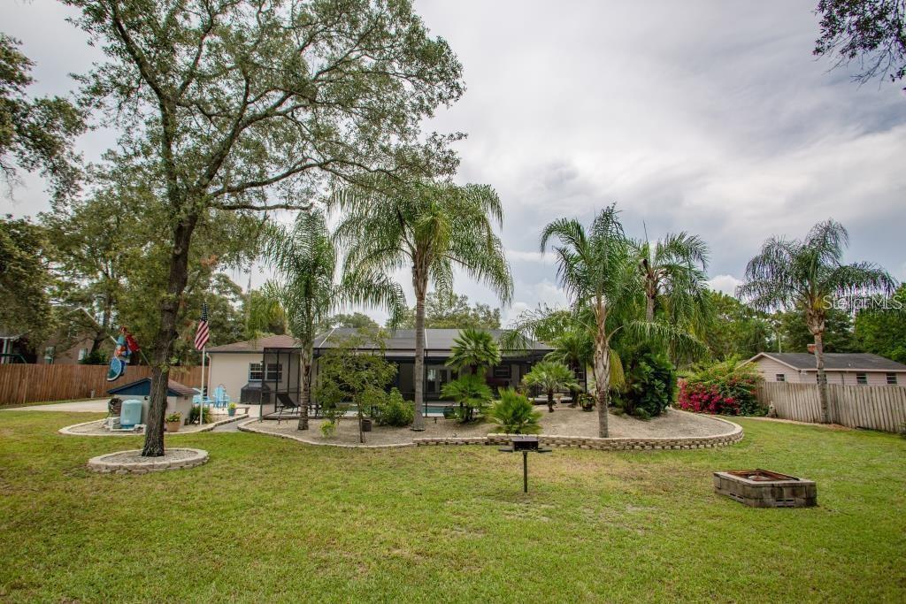 12802 North 53rd Street Temple Terrace, FL 33617 - Photo 28 of 38 a view of a swimming pool with a table and chairs