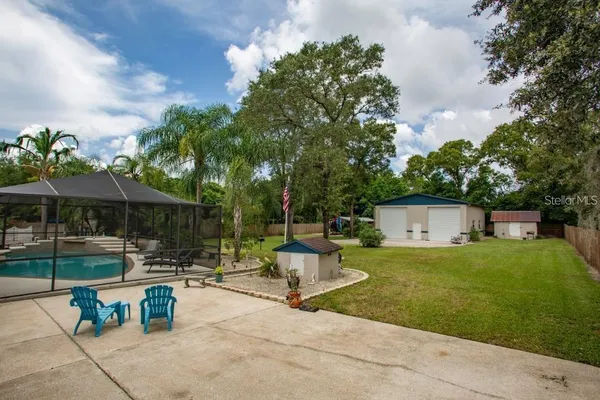 a view of a patio with a table and chairs under an umbrella