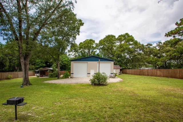 a view of backyard of house with green space