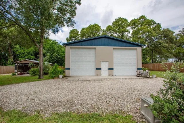 a view of a house with a yard and garage