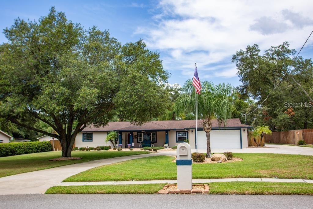 12802 North 53rd Street Temple Terrace, FL 33617 - Photo 32 of 38 a front view of a house with a yard