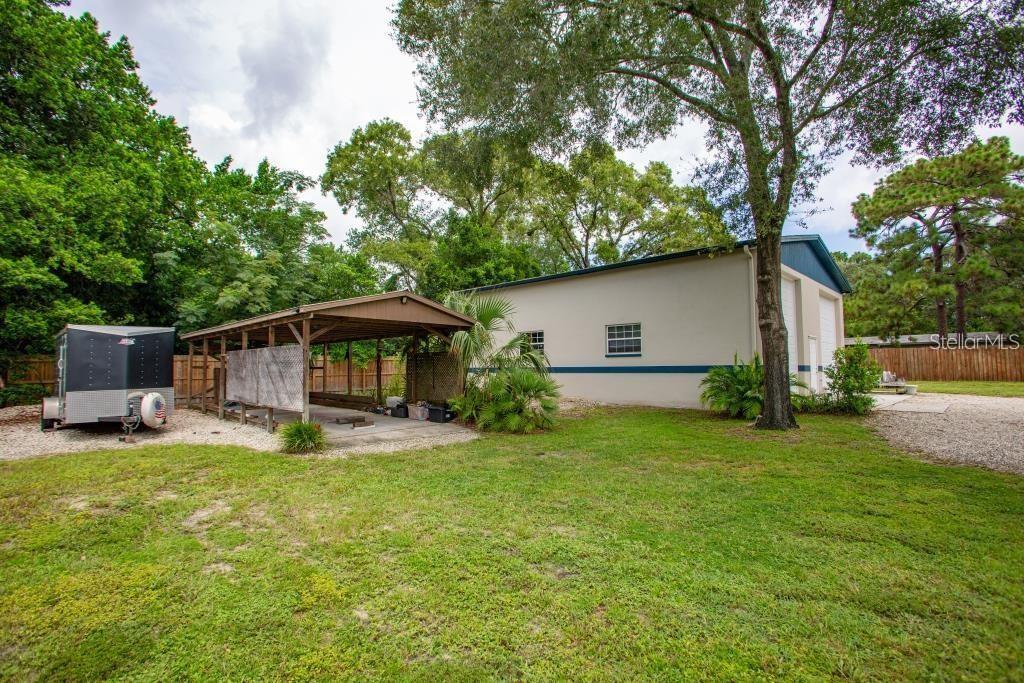 12802 North 53rd Street Temple Terrace, FL 33617 - Photo 36 of 38 a view of a house with backyard and sitting area