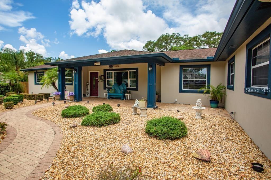 12802 North 53rd Street Temple Terrace, FL 33617 - Photo 4 of 38 a view of a house with porch and entertaining space