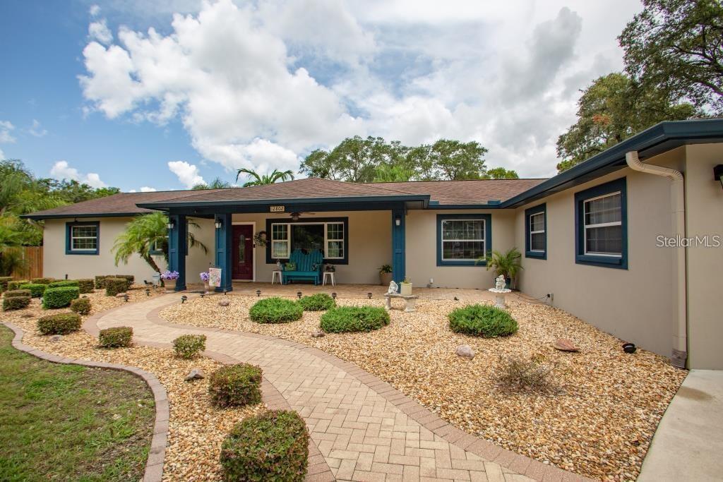12802 North 53rd Street Temple Terrace, FL 33617 - Photo 5 of 38 a front view of house with yard outdoor seating and barbeque oven