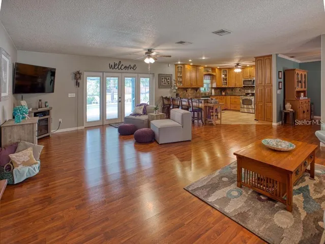 a living room with furniture flat screen tv and wooden floor