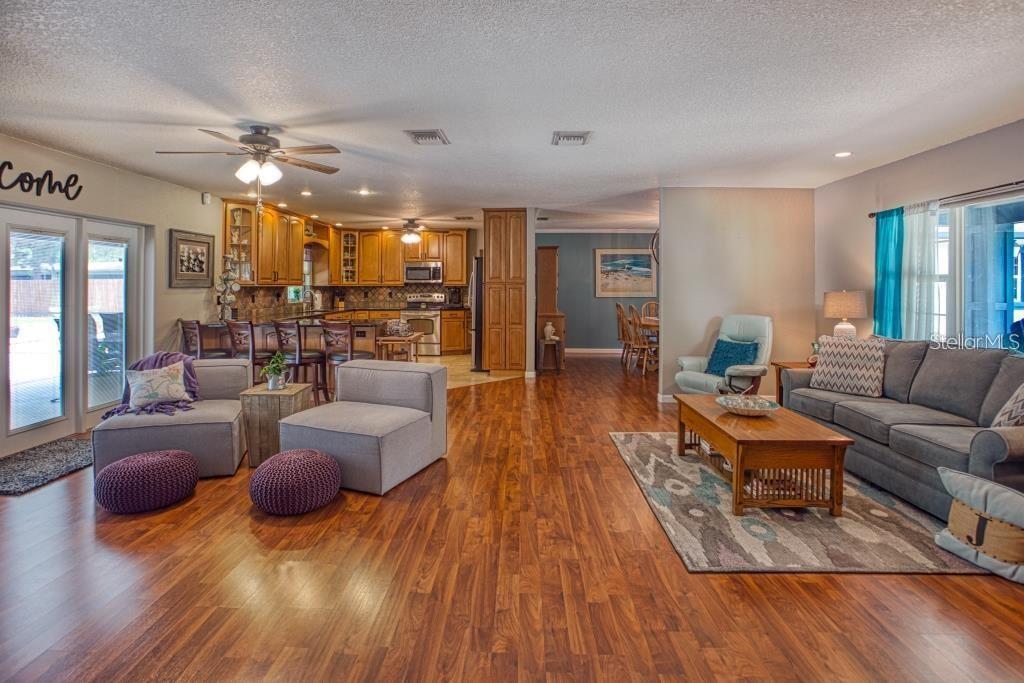 12802 North 53rd Street Temple Terrace, FL 33617 - Photo 7 of 38 a living room with furniture and wooden floor