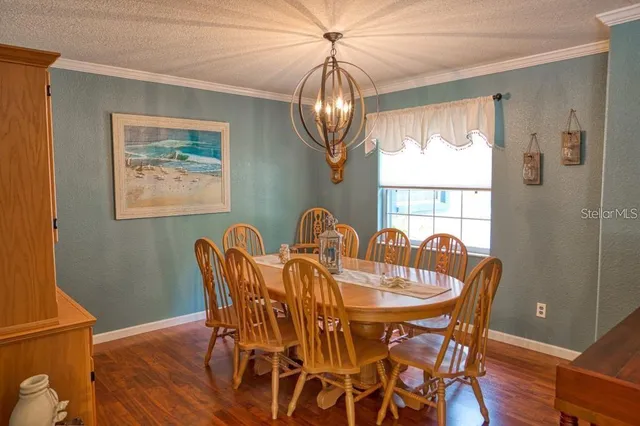 a view of a dining room with furniture wooden floor and a chandelier