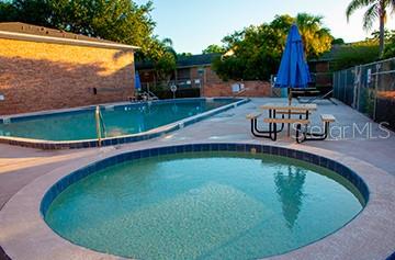 4320 Lake Underhill Road, Unit 14D2 Orlando, FL 32803 - Photo 12 of 15 a view of a swimming pool with a garden