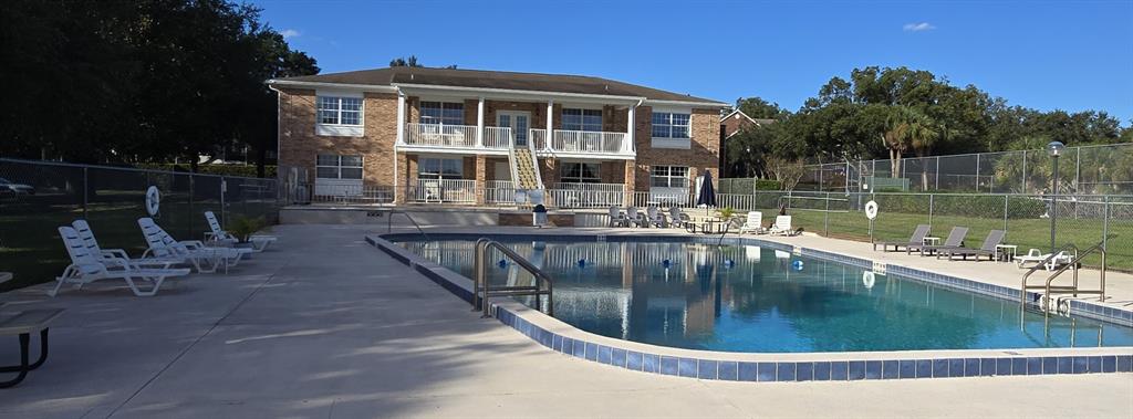 4320 Lake Underhill Road, Unit 14D2 Orlando, FL 32803 - Photo 13 of 15 a view of a swimming pool with sitting area