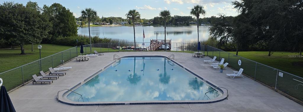 4320 Lake Underhill Road, Unit 14D2 Orlando, FL 32803 - Photo 14 of 15 a view of a swimming pool with a yard and green space