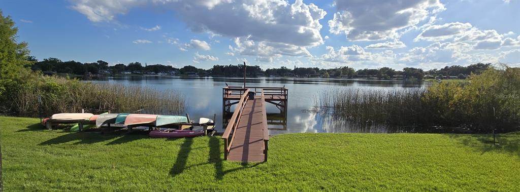 4320 Lake Underhill Road, Unit 14D2 Orlando, FL 32803 - Photo 15 of 15 a backyard of a house with table and lake view