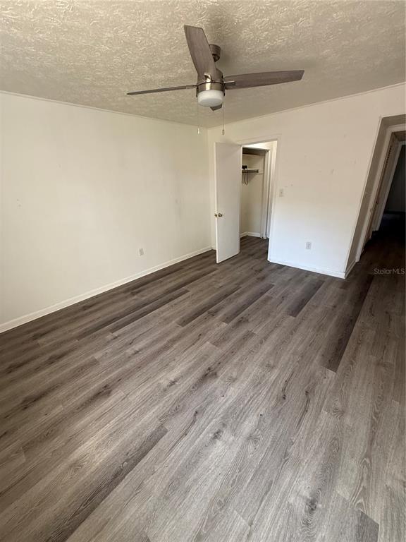 4320 Lake Underhill Road, Unit 14D2 Orlando, FL 32803 - Photo 4 of 15 a view of a room with wooden floor and a ceiling fan