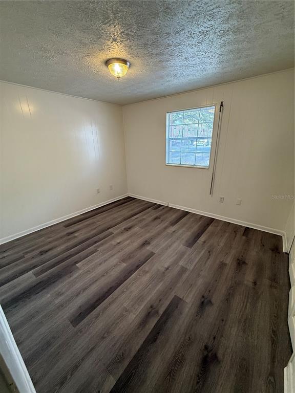 4320 Lake Underhill Road, Unit 14D2 Orlando, FL 32803 - Photo 6 of 15 an empty room with wooden floor and windows