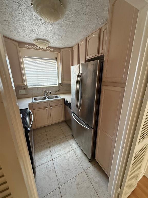 4320 Lake Underhill Road, Unit 14D2 Orlando, FL 32803 - Photo 9 of 15 a kitchen with stainless steel appliances granite countertop a refrigerator and a sink