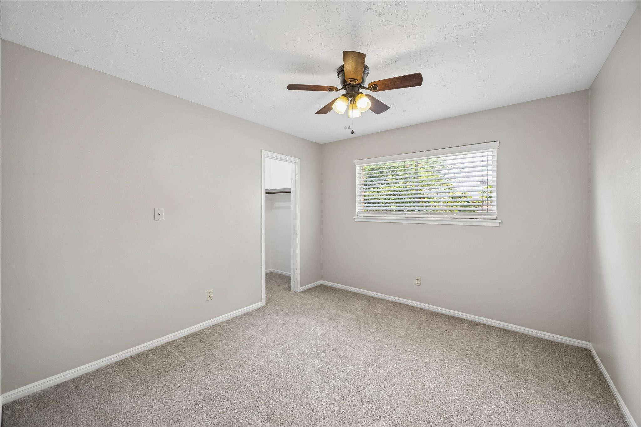 25114 Spring Ridge Drive Spring, TX 77386 - Photo 17 of 24 an empty room with windows and fan