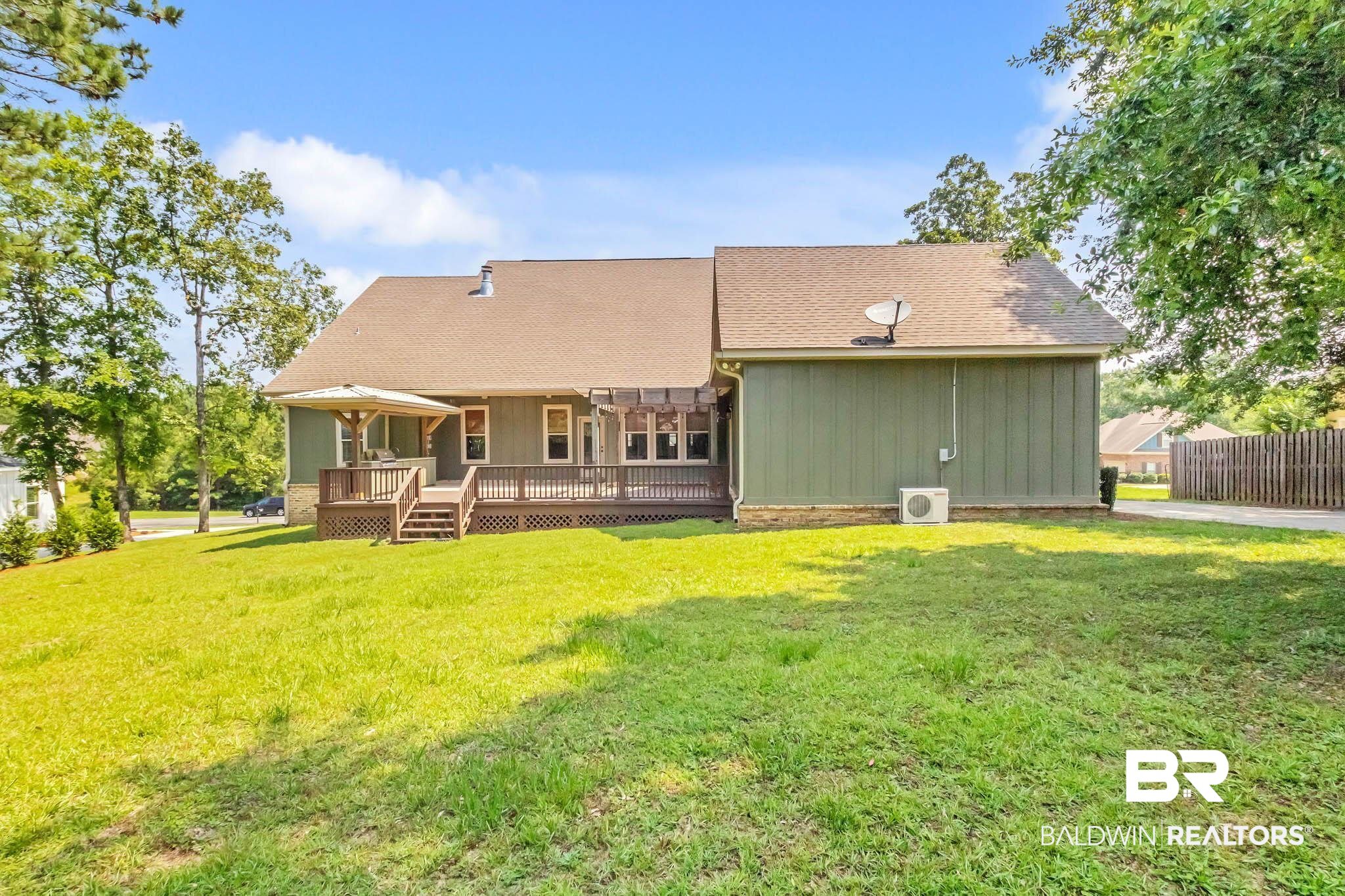 7854 Raegan Lane Daphne, AL 36527 - Photo 53 of 70 Rear view of property featuring a deck, a yard, board and batten siding, and a shingled roof