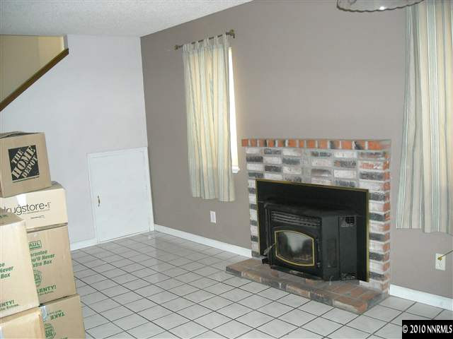 2782 Azuza Way Reno, NV 89502 - Photo 2 of 9 a room with a fireplace and a window