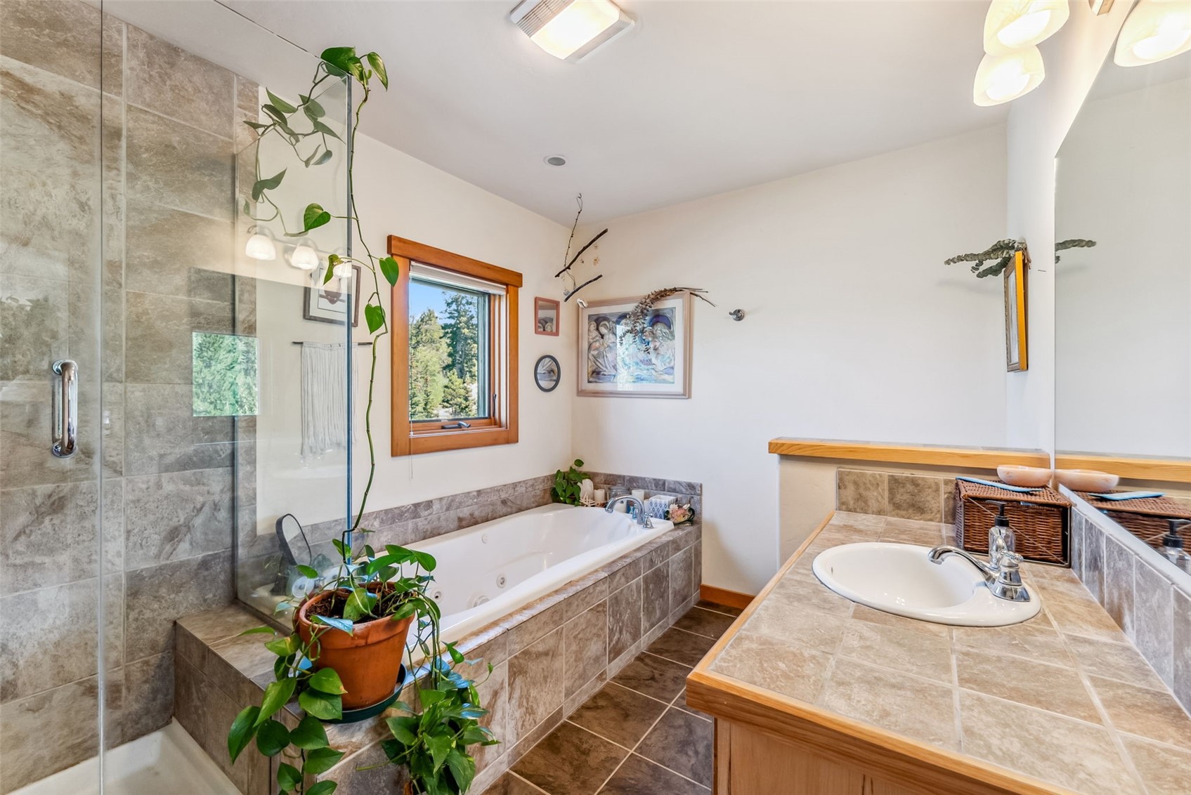 228 Glacier Ridge Road Alma, CO 80420 - Photo 19 of 50 a bathroom with a granite countertop tub a sink and a mirror