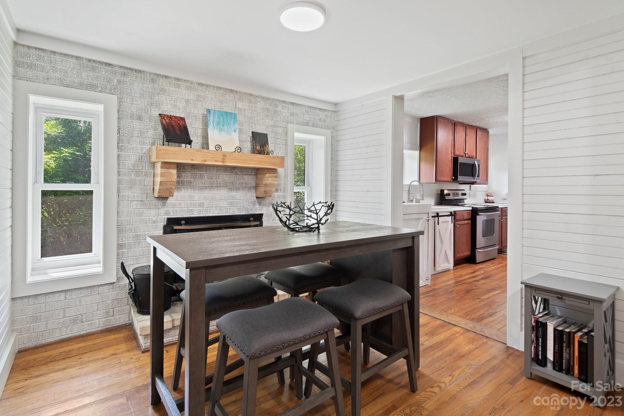 115 James E Davis Drive Mills River, NC 28759 - Photo 13 of 27 a kitchen with a dining table chairs and a stove