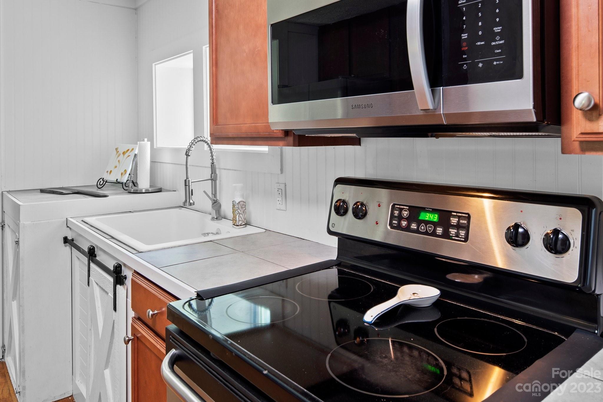 115 James E Davis Drive Mills River, NC 28759 - Photo 15 of 27 a kitchen with a stove and a microwave