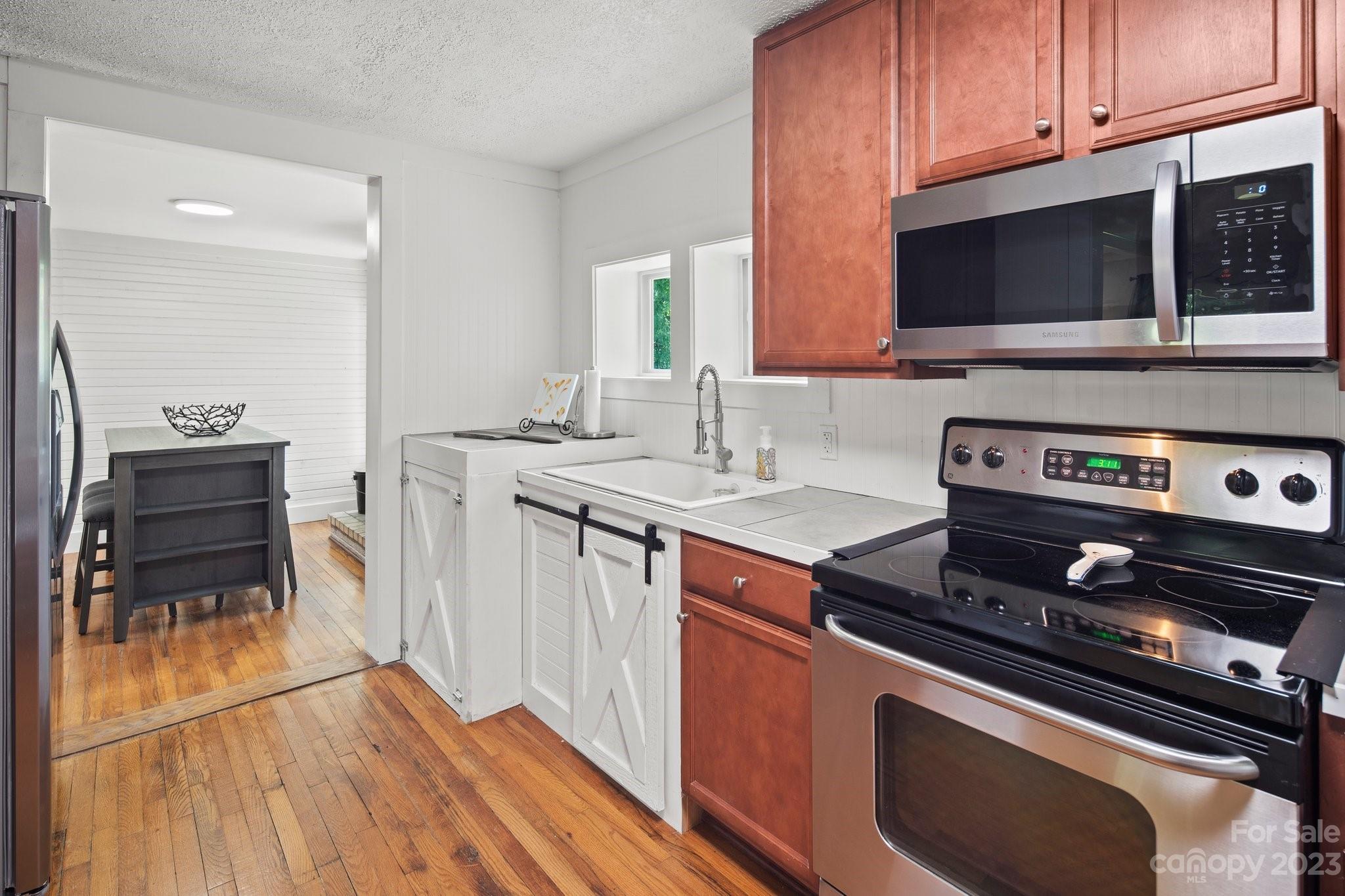 115 James E Davis Drive Mills River, NC 28759 - Photo 16 of 27 a kitchen with a stove and a microwave