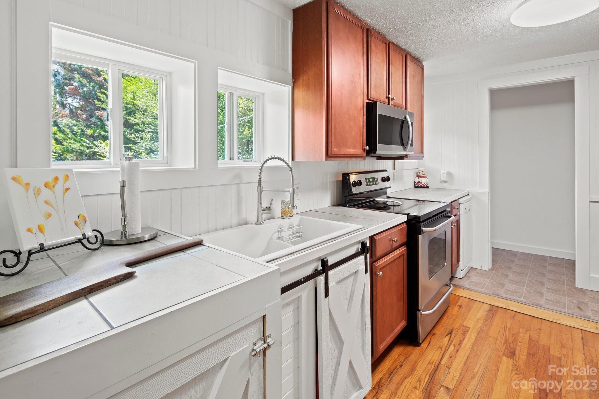 115 James E Davis Drive Mills River, NC 28759 - Photo 18 of 27 a kitchen with a sink and a window