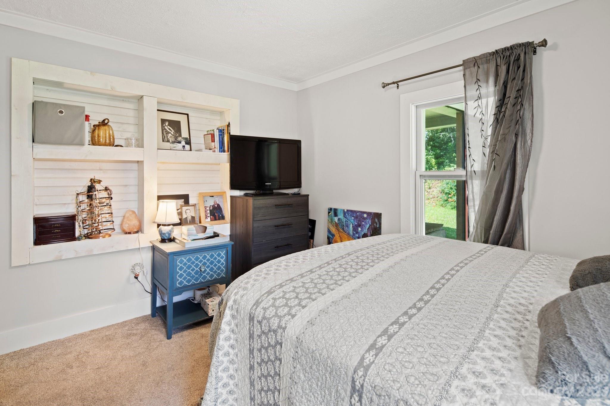 115 James E Davis Drive Mills River, NC 28759 - Photo 24 of 27 a bedroom with a bed and a flat screen tv