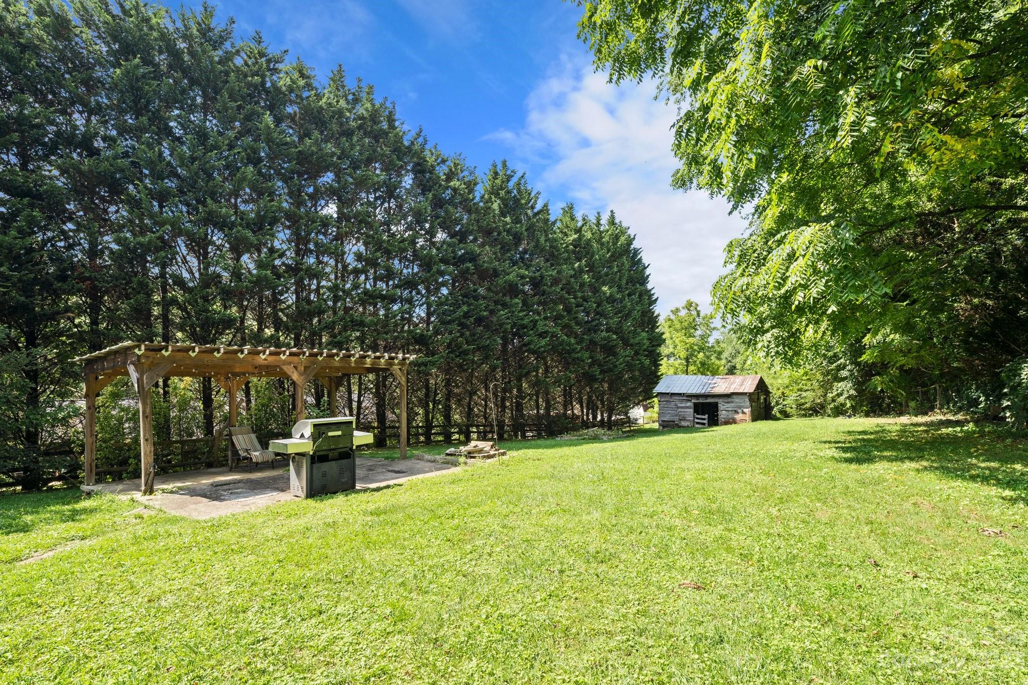 115 James E Davis Drive Mills River, NC 28759 - Photo 27 of 27 a view of a house with backyard and sitting area