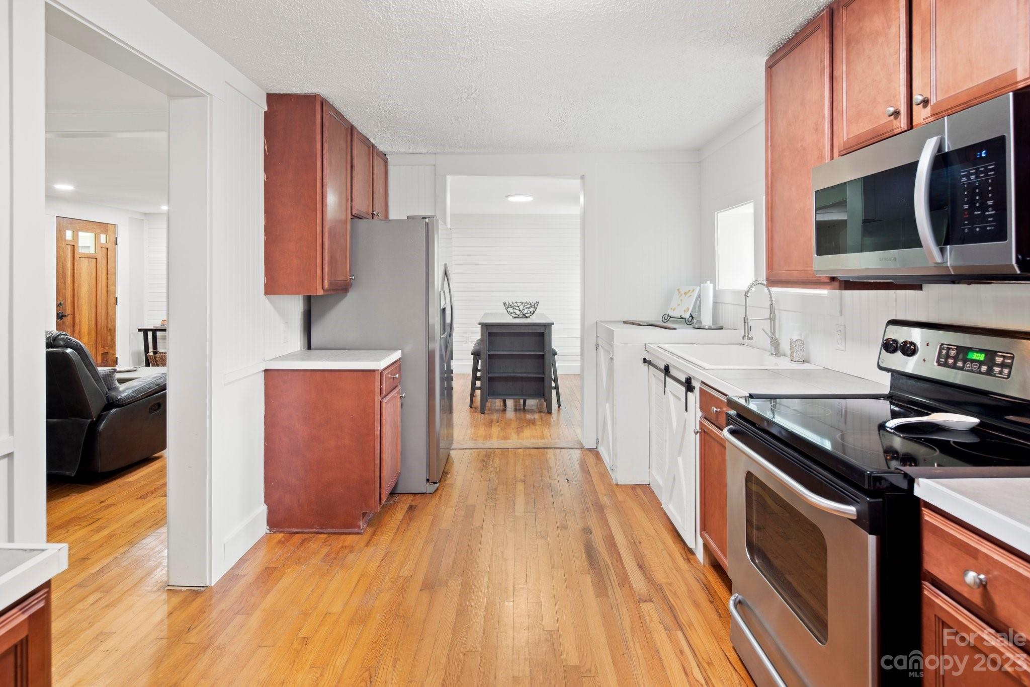 115 James E Davis Drive Mills River, NC 28759 - Photo 10 of 27 a kitchen with stainless steel appliances granite countertop a stove a sink and a microwave