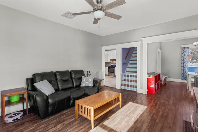 a living room with furniture and wooden floor