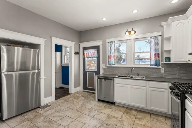 a kitchen with stainless steel appliances a sink stove and refrigerator