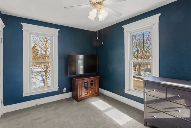 wooden floor chandelier and windows in a room