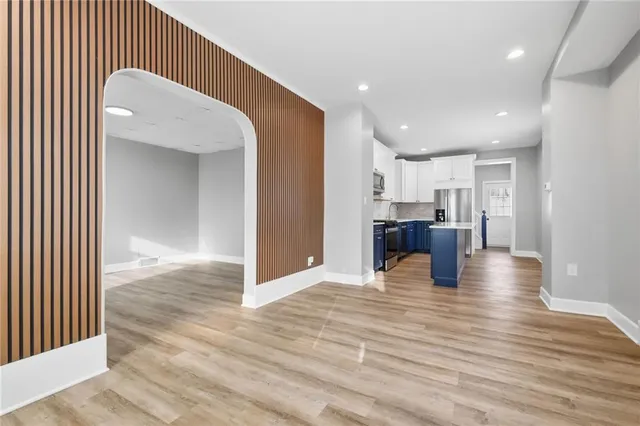 a view of kitchen and a livingroom with wooden floor