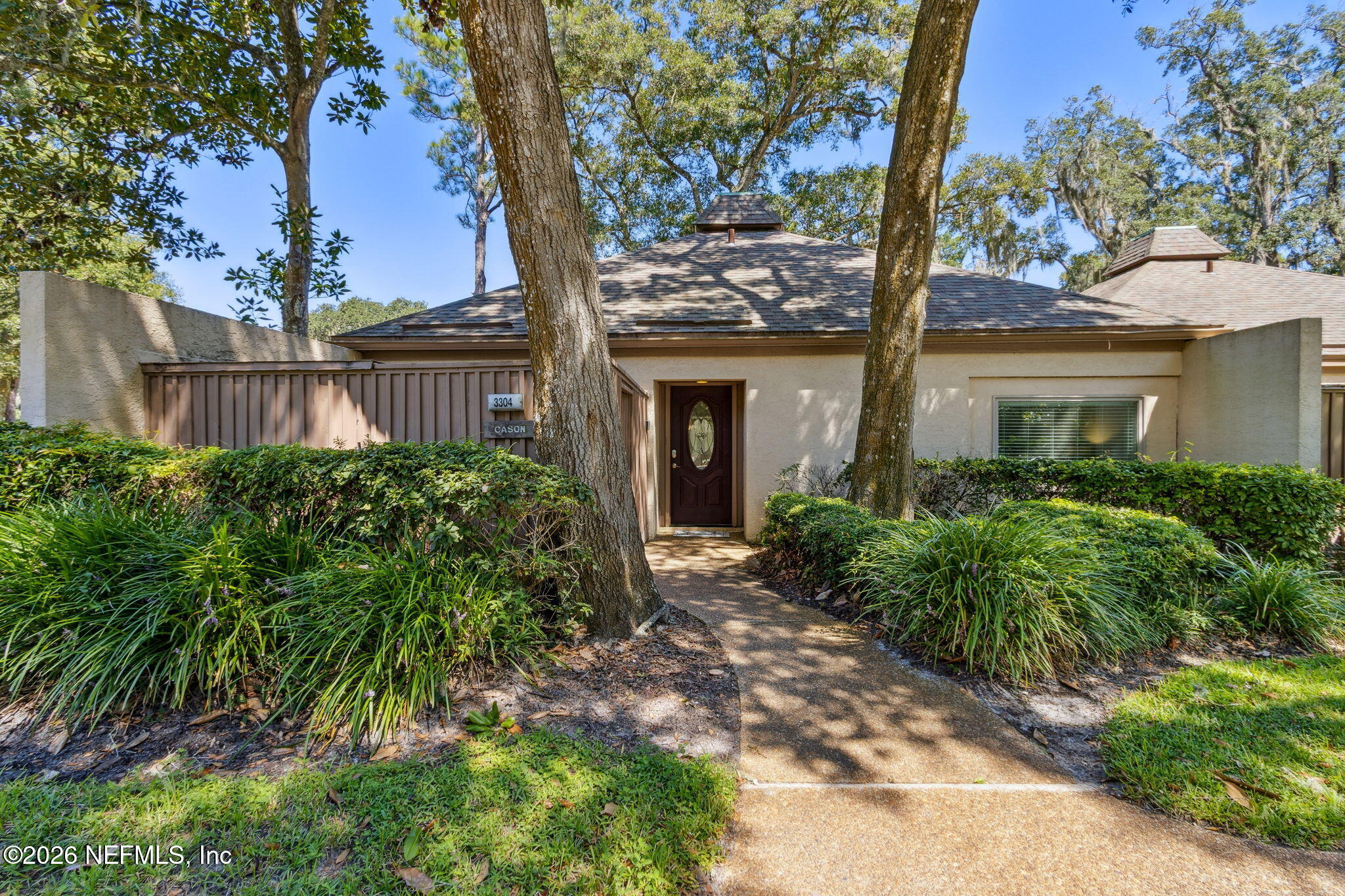 a view of a house with a tree in front of it