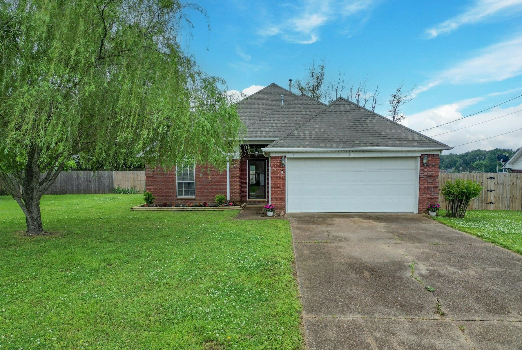 a view of backyard of house with green space