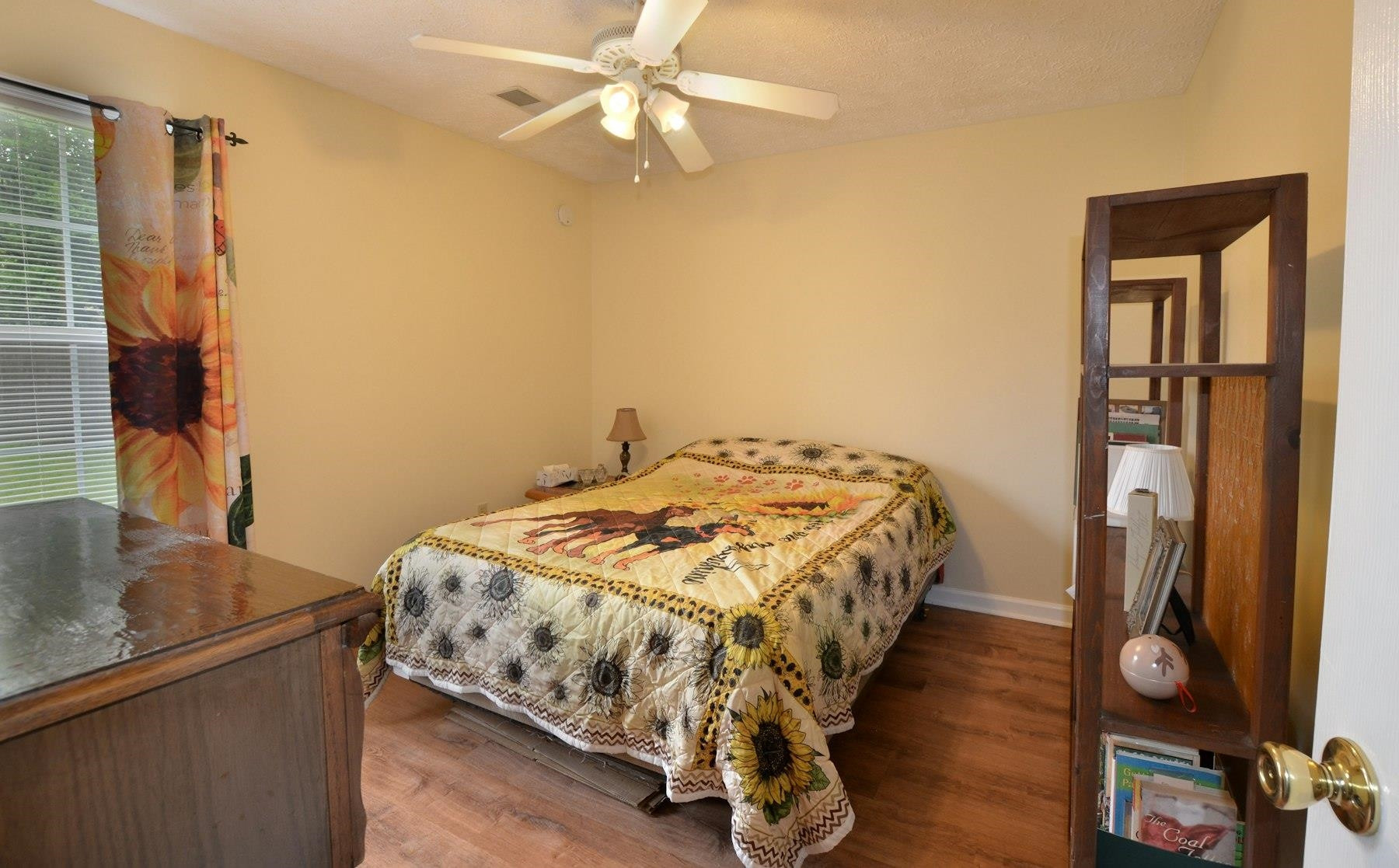 611 Gettysburg Drive Jackson, TN 38305 - Photo 16 of 19 a bedroom with a bed and a chandelier