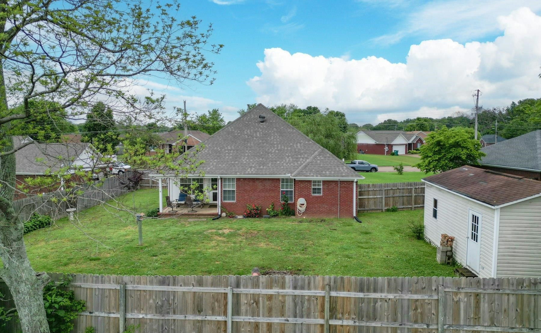 611 Gettysburg Drive Jackson, TN 38305 - Photo 5 of 19 a view of a house with a big yard and potted plants