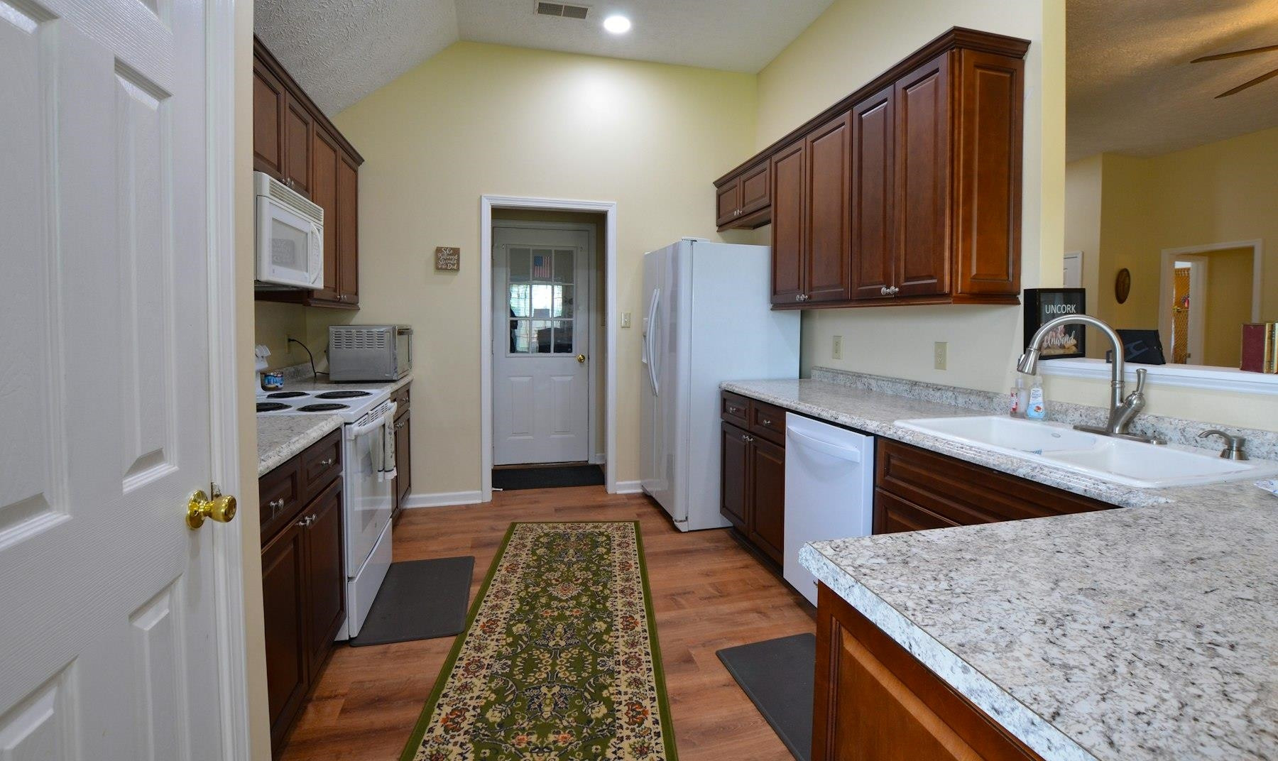 611 Gettysburg Drive Jackson, TN 38305 - Photo 9 of 19 a kitchen with granite countertop wooden cabinets a stove top oven a sink and dishwasher