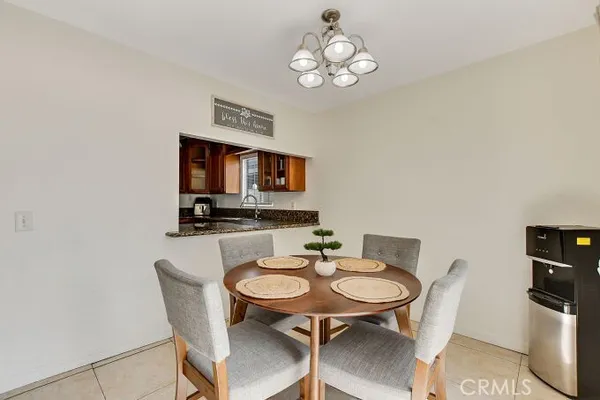 a view of a dining room with furniture and a chandelier