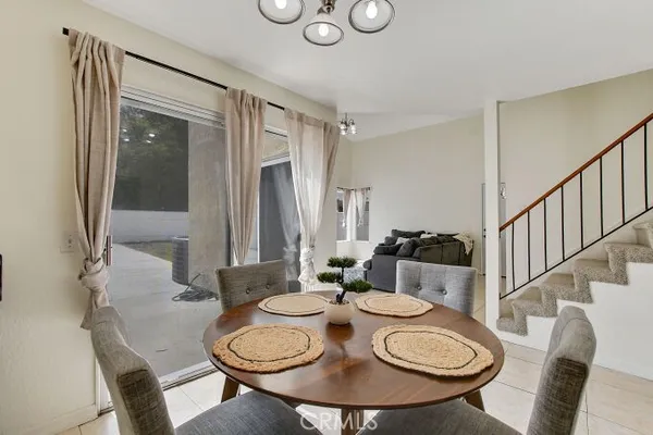 a dining room with furniture a rug and wooden floor