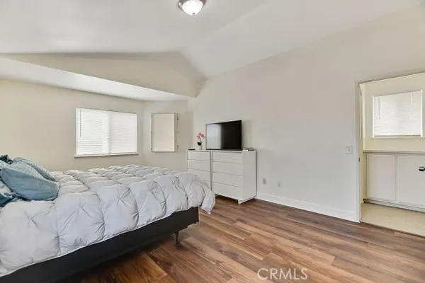 a bedroom with a bed and a tv